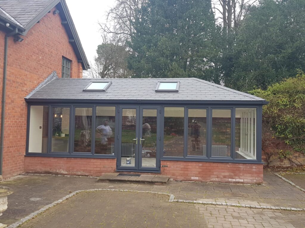 Large Conservatory with Anthracite grey frames and a warm tiled roof