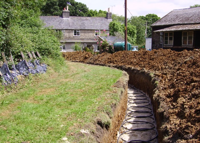 a photograph of heat pump loops being installed in a domestic garden