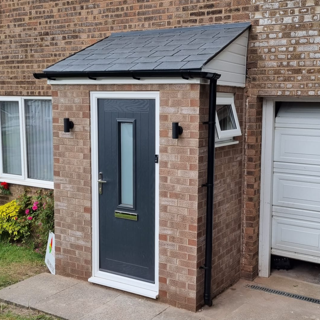 a photograph of an anthracite grey composite door on a porch