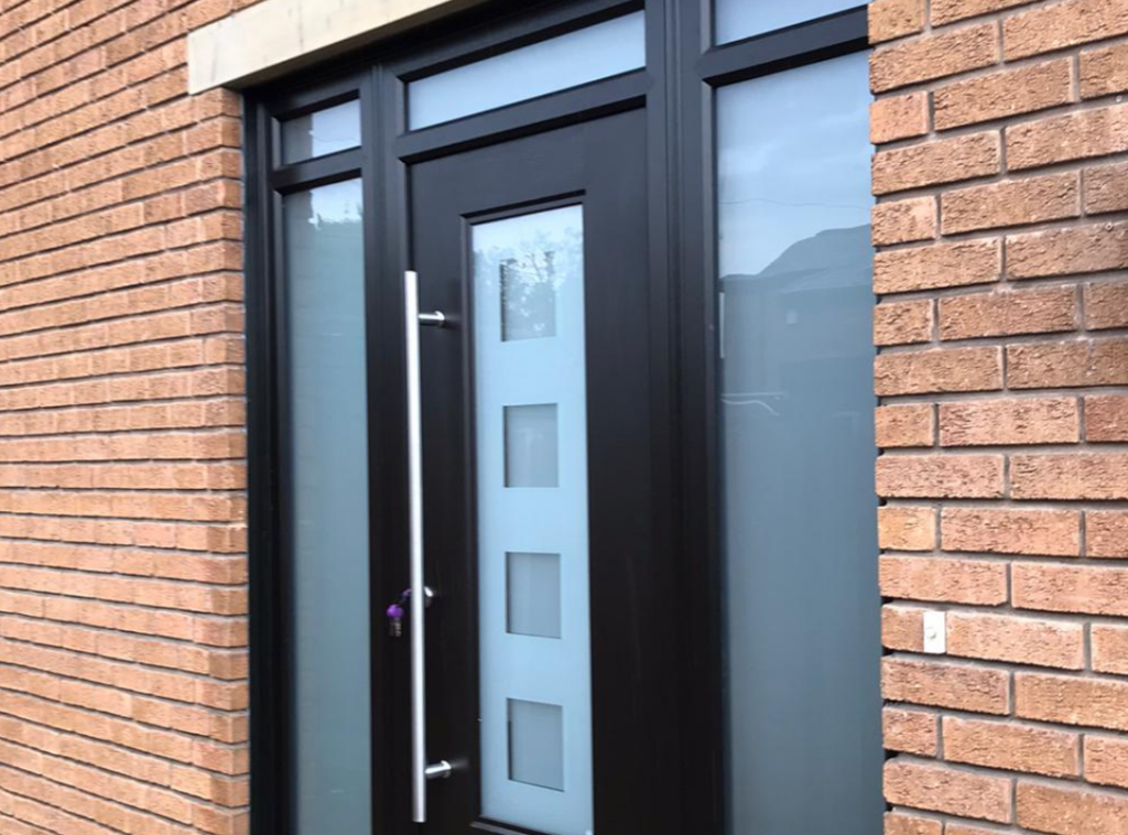a photograph of a black rockdoor with frosted glass side panels